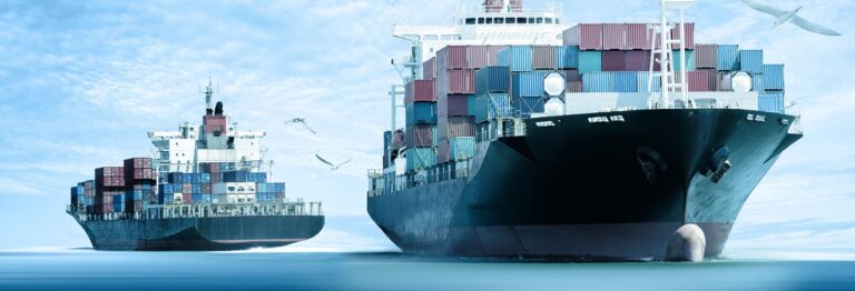 Two large cargo ships with stacked containers on a calm sea