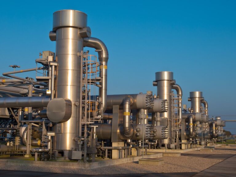 Gas processing plant with stainless columns and piping at dusk