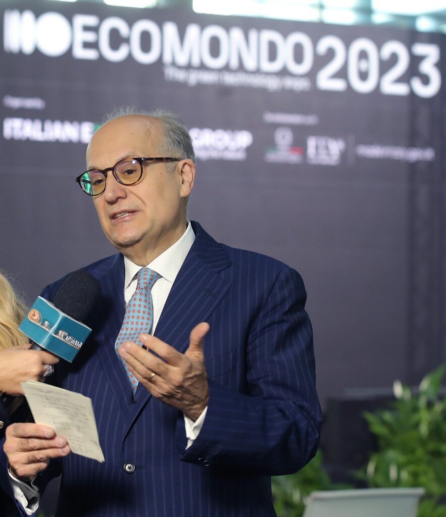 Speaker giving a television interview in front of the Ecomondo backdrop at a previous edition of the show