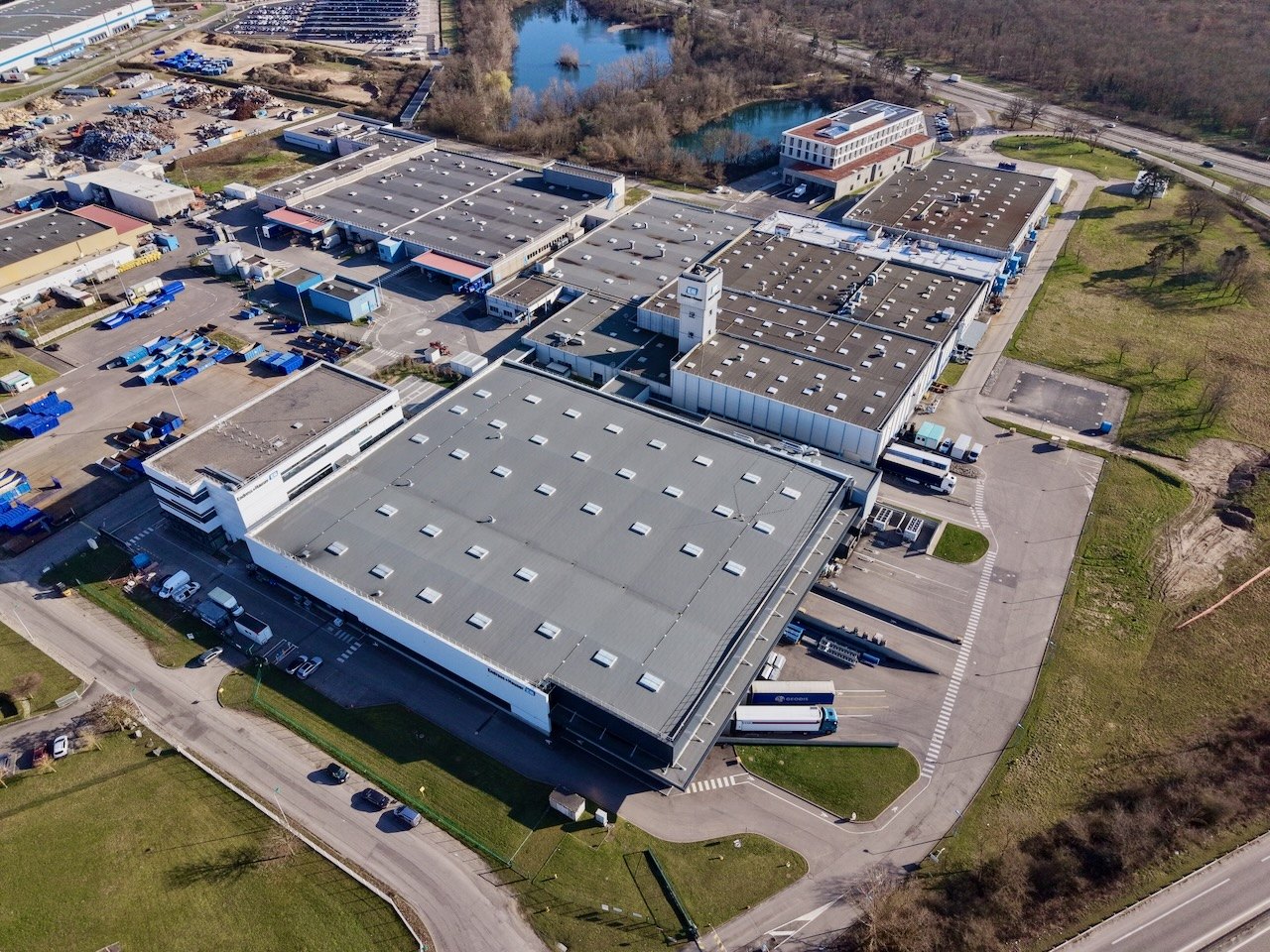 Aerial view of the Endress+Hauser campus in Cernay with production halls, offices and surrounding green land