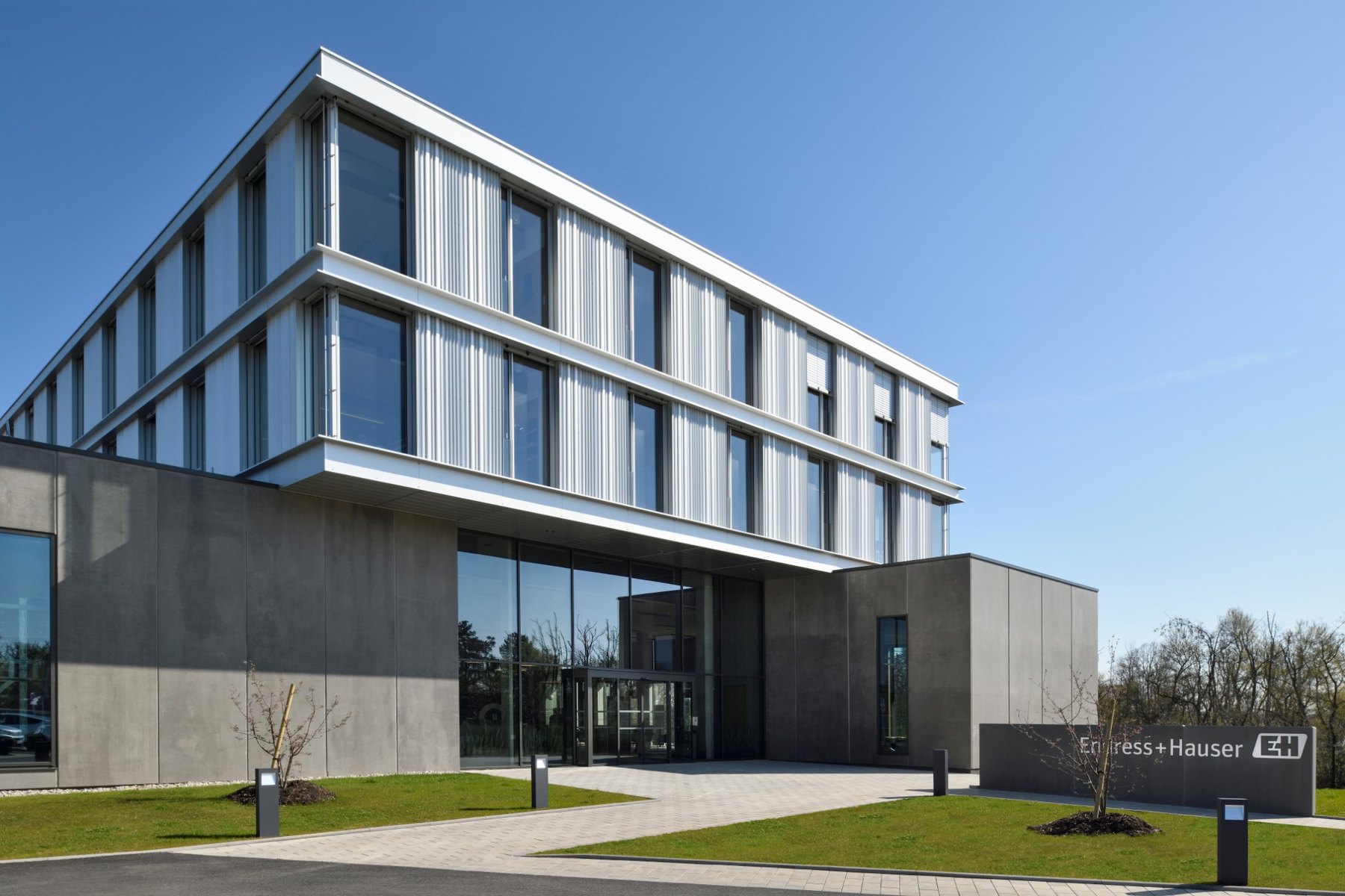 Modern three-storey office building with glass and metal facade housing the Endress+Hauser sales center in Cernay, France