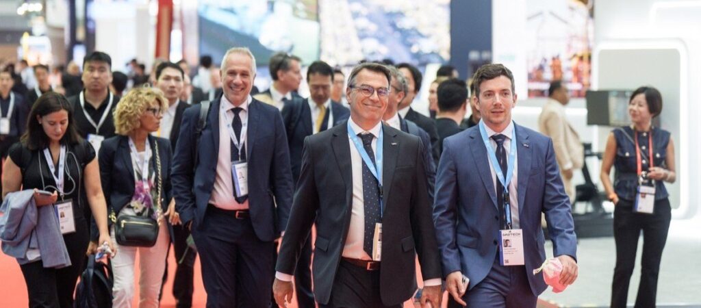 Delegates walking through the busy exhibition aisles at Gastech