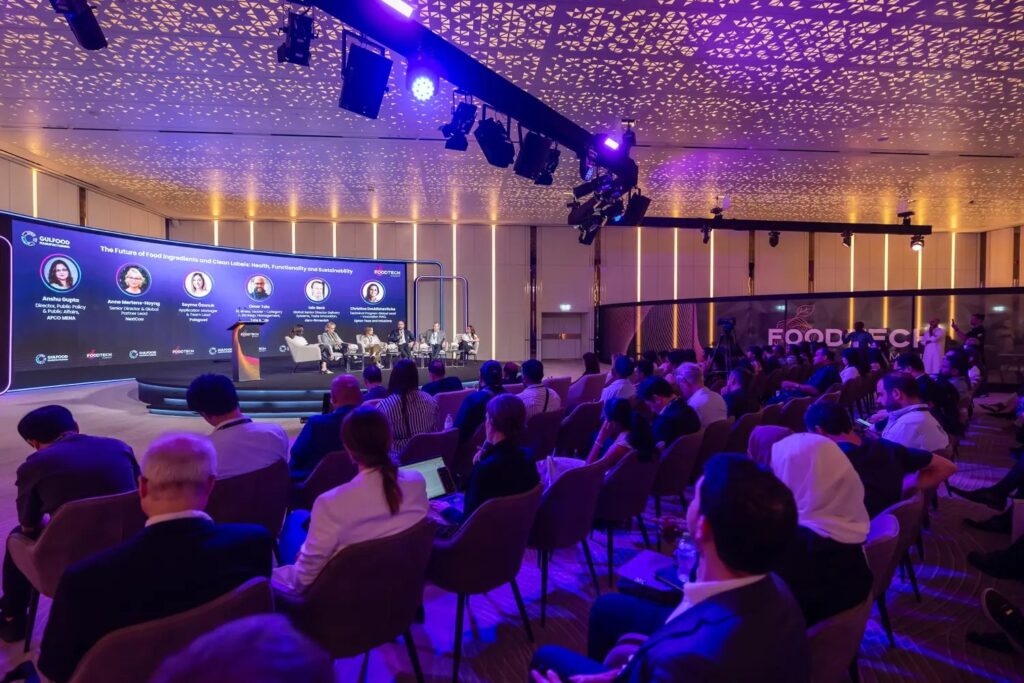 Audience at a panel session on the conference stage of Gulfood Manufacturing in Dubai