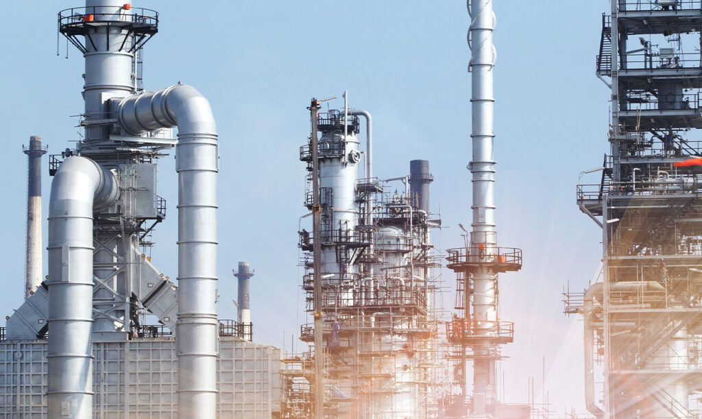 Industrial plant with steel columns and pipework under a blue sky