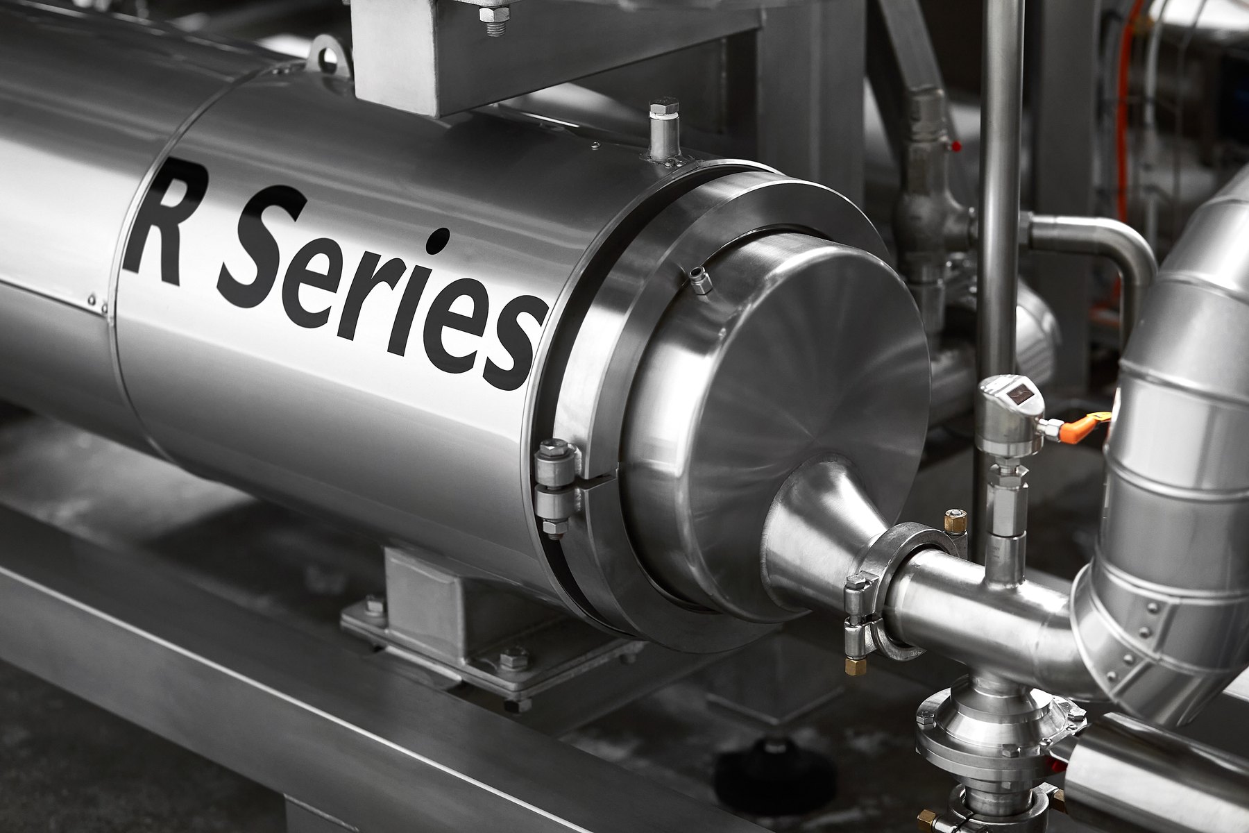 Close-up of an HRS R Series rotating scraped surface heat exchanger with R Series lettering on the shell