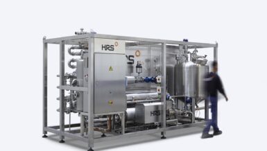 Compact HRS Thermblock pasteuriser on a stainless steel skid frame with control cabinet and product tank