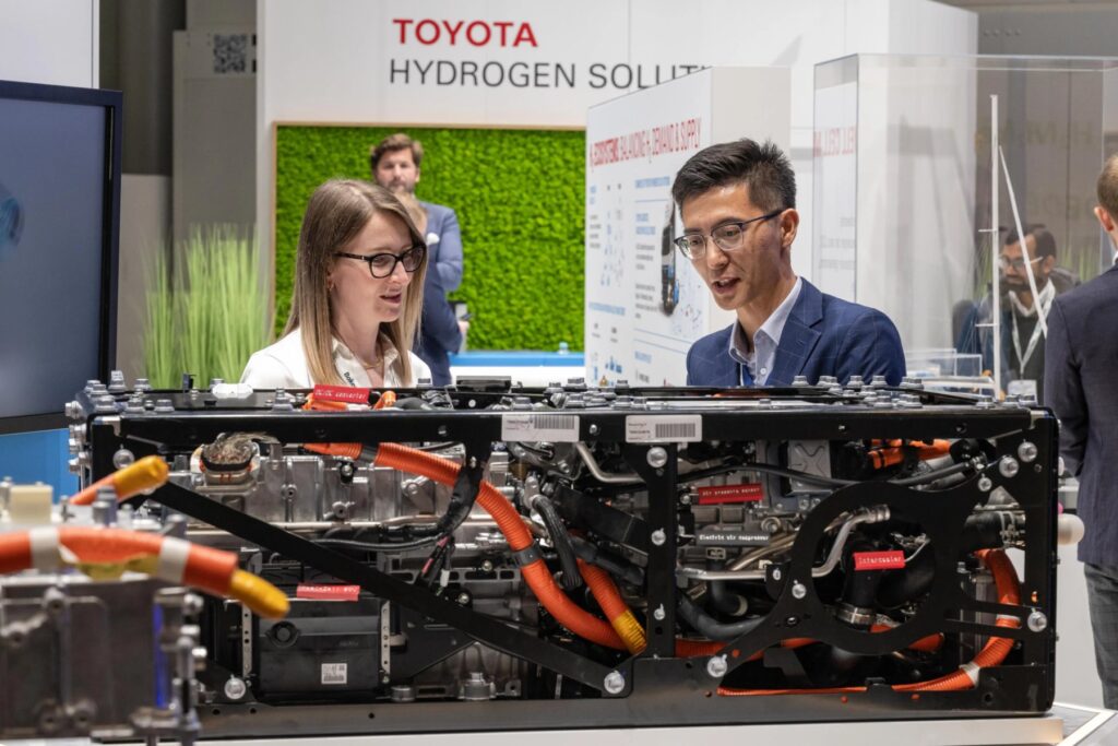 Visitors at an exhibitor stand at Hydrogen Technology World Expo in Hamburg Messe