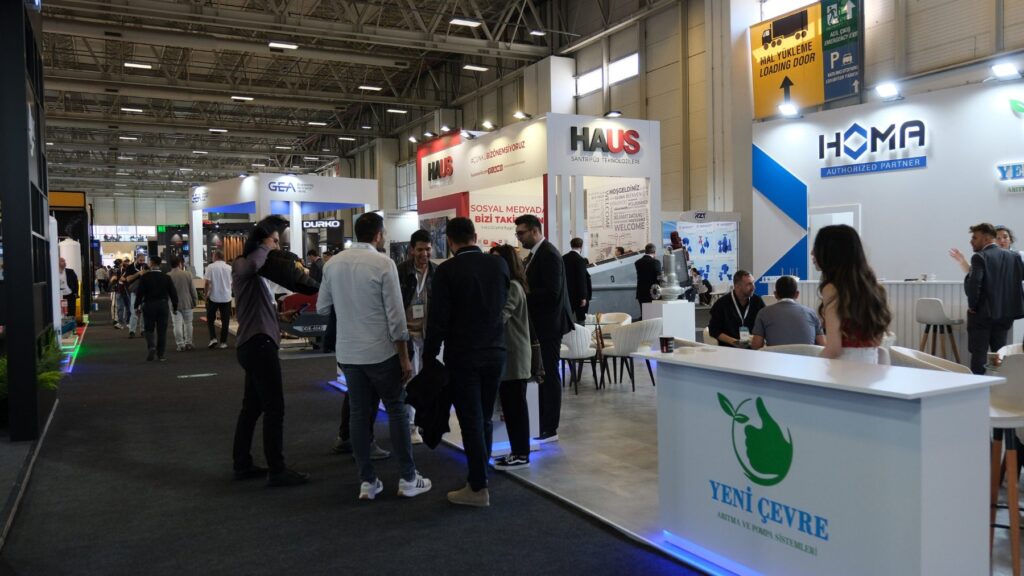 Visitors walking past exhibitor stands in the exhibition hall of IFAT Eurasia