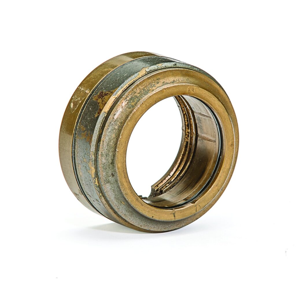 Original bronze bearing isolator with visible wear from service