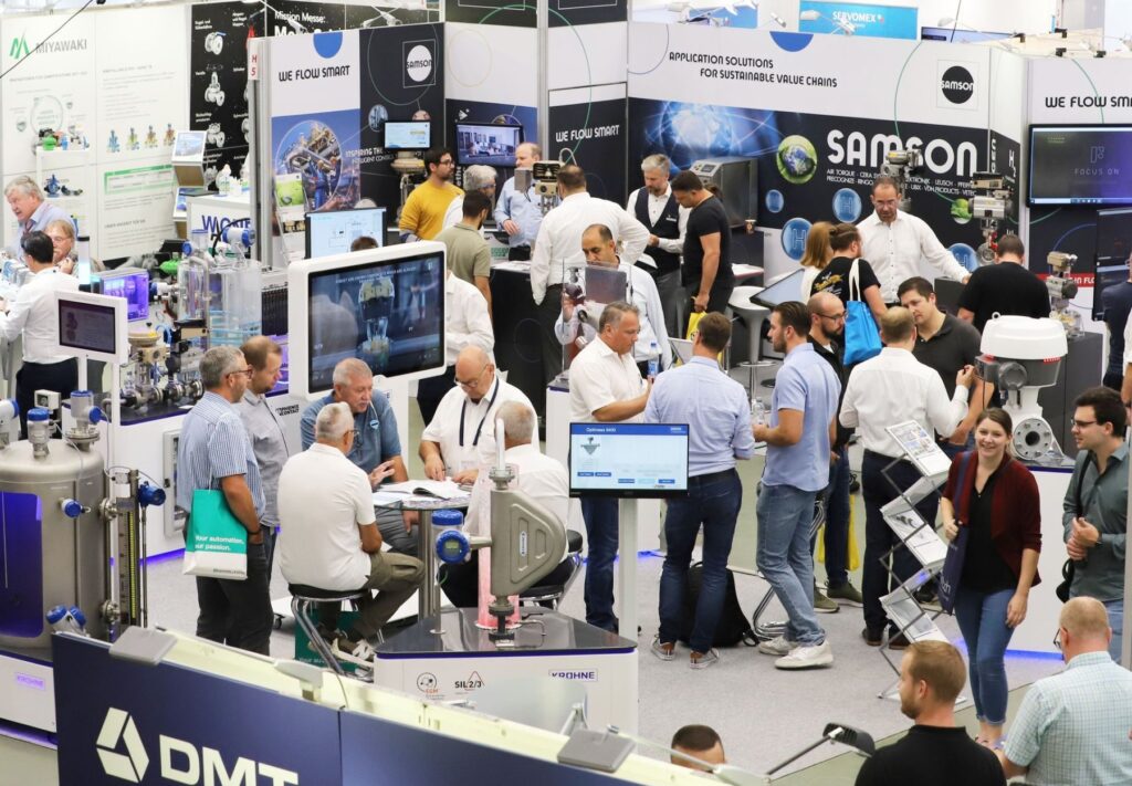 Visitors at exhibitor stands at a MEORGA MCR Solution Fair