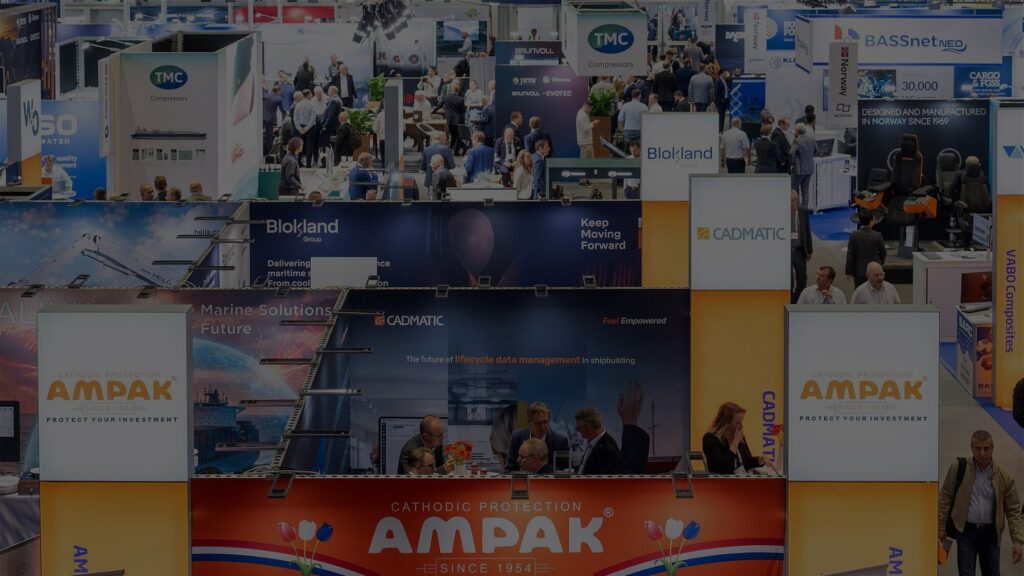 Exhibitor stands and visitors in a busy exhibition hall at SMM in Hamburg