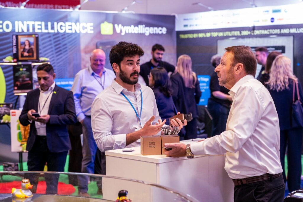 Visitors networking at an exhibitor stand at Utility Week Live, NEC Birmingham