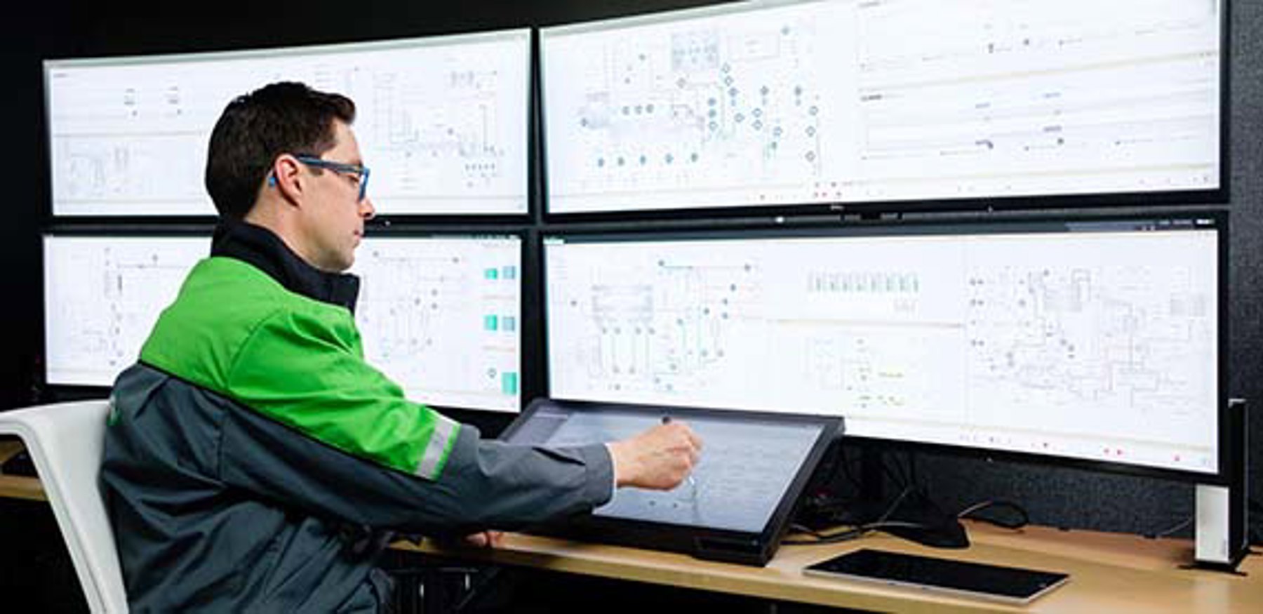 Operator working with the Valmet DNA distributed control system for real-time process control