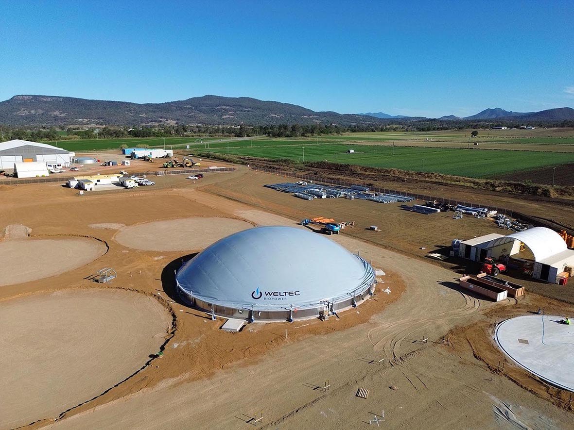 Aerial view of a WELTEC BIOPOWER stainless steel digester with membrane roof at a bioenergy plant construction site in Queensland, Australia