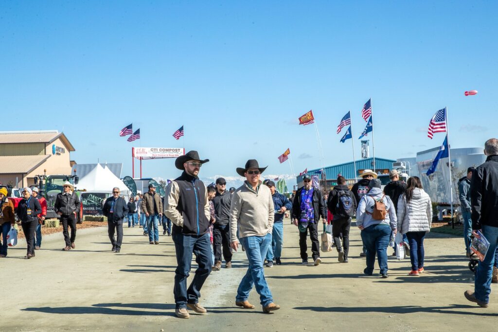 Visitors walking across the World Ag Expo show grounds in Tulare